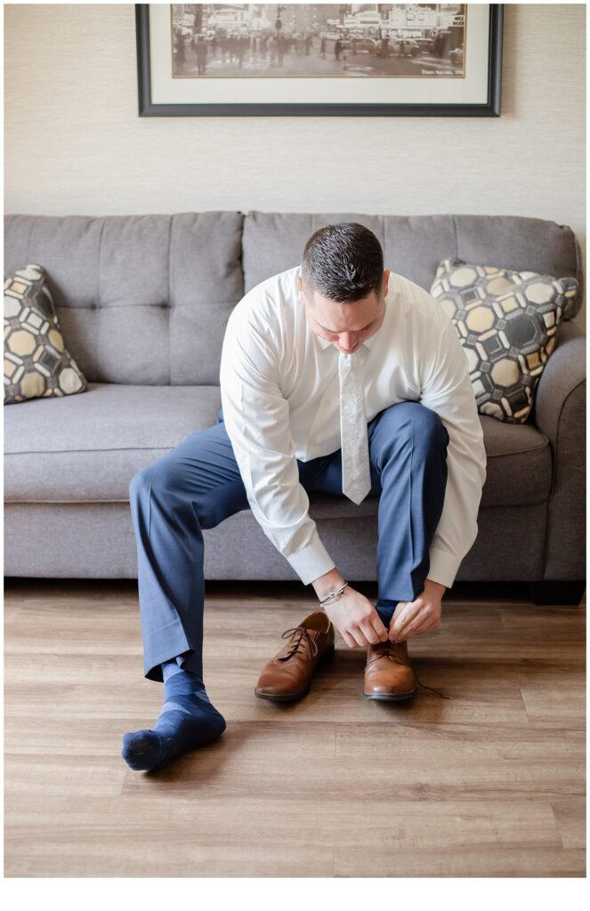 groom putting on shoes