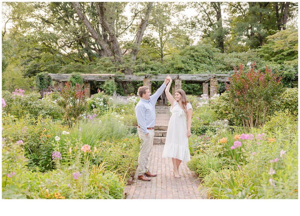 girl twirling for engagement photos at cross estate gardens