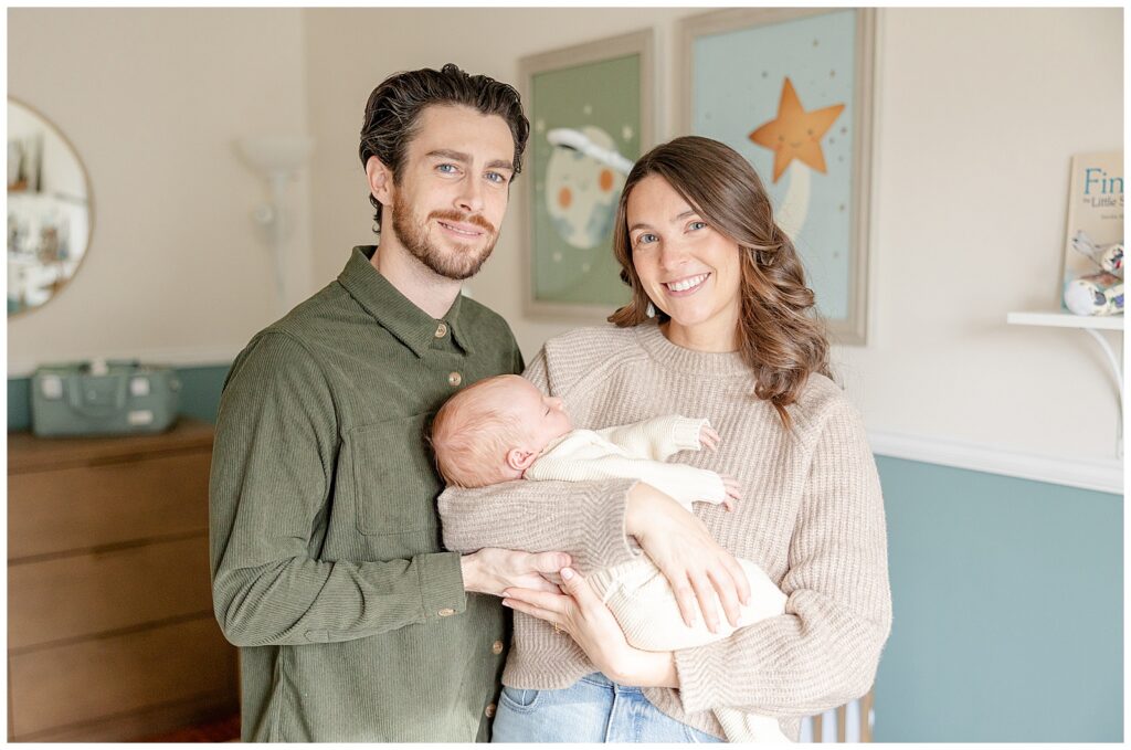 Parents holding newborn during New Jersey lifestyle newborn session