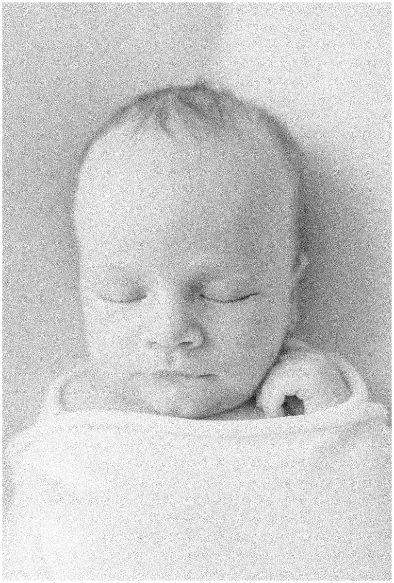 New Jersey newborn lifestyle session with baby Finn wrapped in a soft neutral blanket